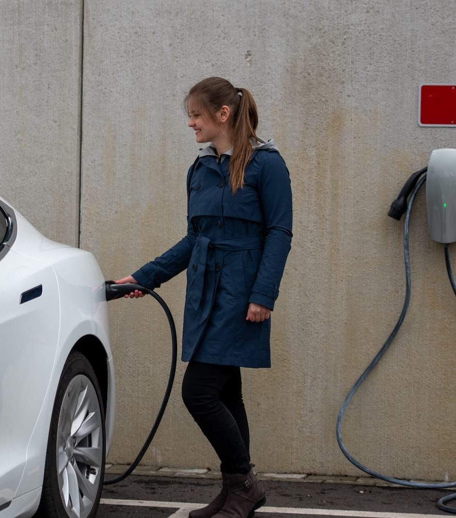 a person standing in front of a car